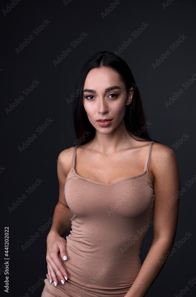 portrait of a young woman in the studio on a dark background portrait of a young woman in the studio on a dark background
