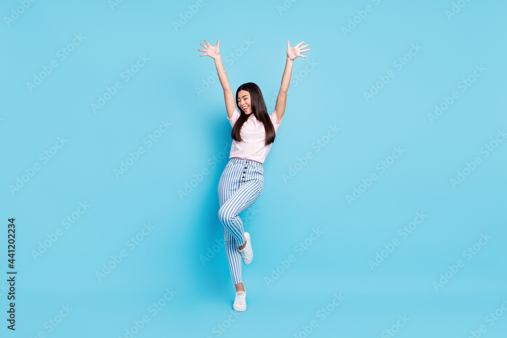 Full size photo of young excited attractive girl happy positive smile show palms wear casual outfit isolated over blue color background