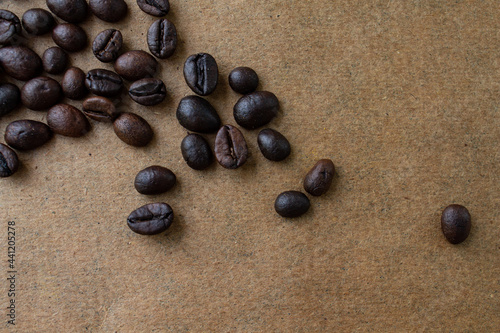 coffee beans are scattered on a brown background.