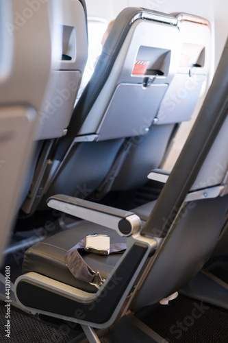 Interior of an empty airplane. Empty aircraft seats with seat belts