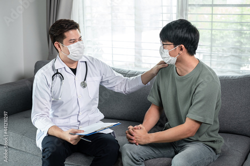 Man doctor in medical face mask holding document clipboard to discussion about result heath examination and encourage