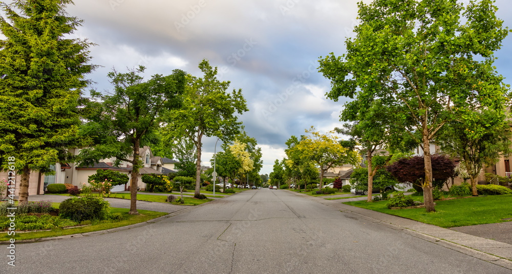 Residential Suburban Neighborhood in the Modern City during a vibrant spring sunset. Taken in Fraser Heights, Surrey, Vancouver, BC, Canada. Panorama