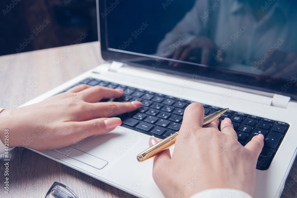 female hands typing on laptop female hands typing on laptop