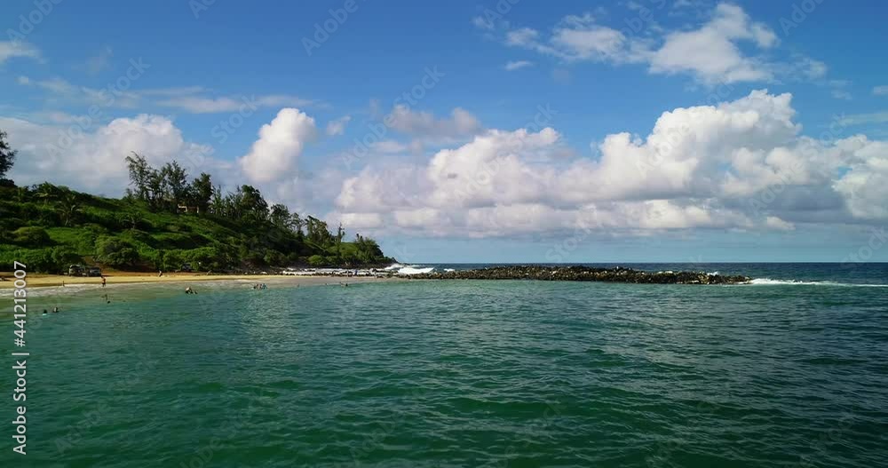 Aerial: Groyne In Sea Against Cloudy Sky, People Enjoying Vacation At Beach On Sunny Day - Kauai, Hawaii Aerial: Groyne In Sea Against Cloudy Sky, People Enjoying Vacation At Beach On Sunny Day - Kauai, Hawaii