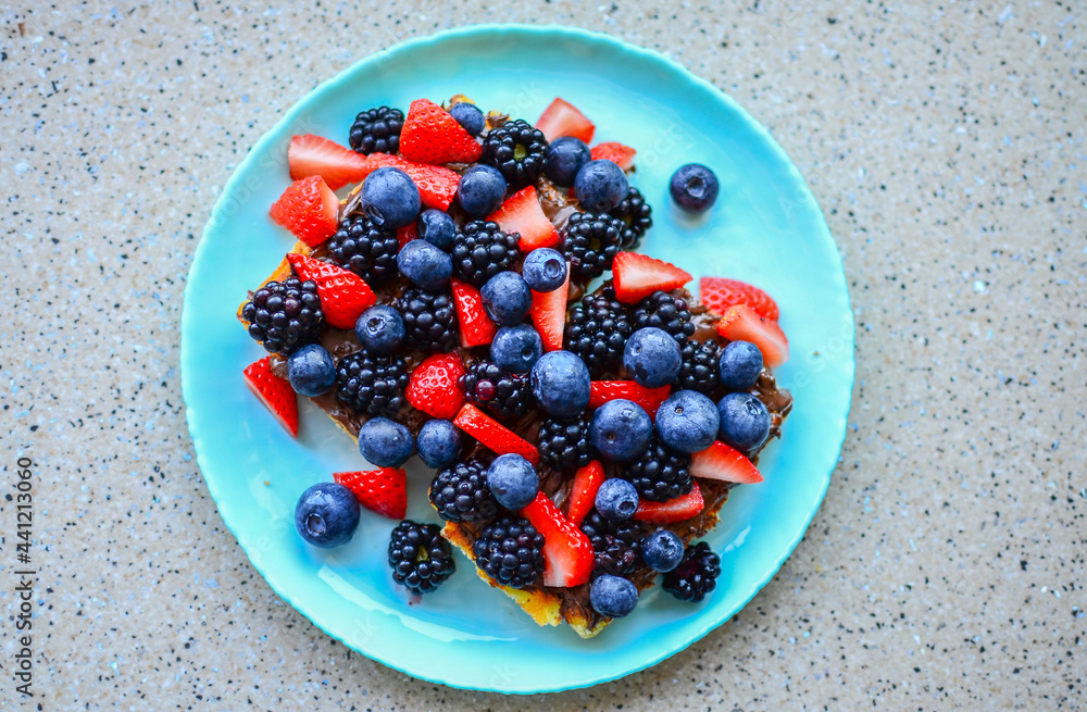 Delicious Waffles with fresh berries and chocolate Delicious Waffles with fresh berries and chocolate