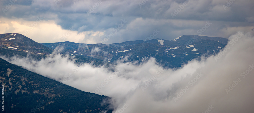 Fog rises over the Carpathian mountains after rain in the evening