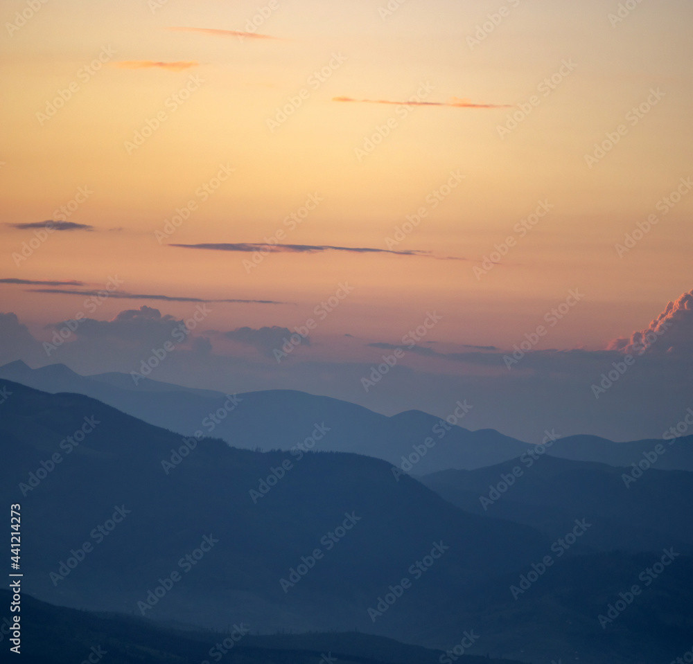 Panorama, smoky silhouette of the Carpathian mountains at sunset