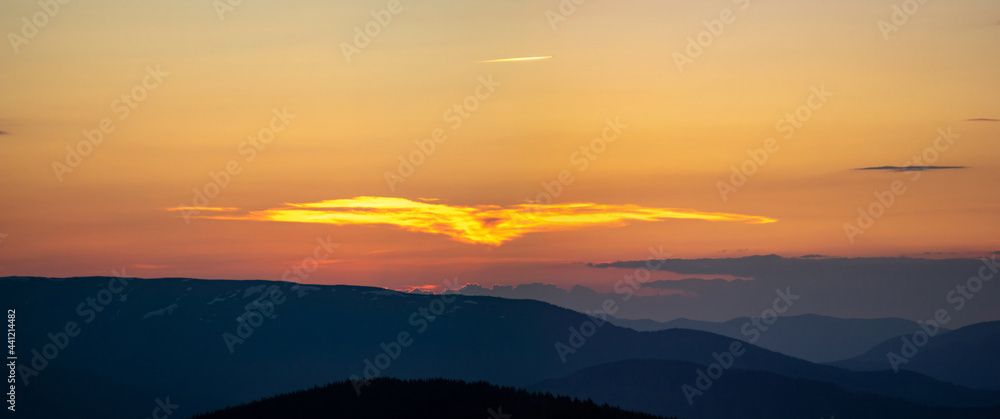 Beautiful colorful orange clouds at sunset, beautiful summer landscape in the evening in the Carpathians