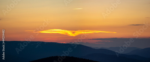 Beautiful colorful orange clouds at sunset, beautiful summer landscape in the evening in the Carpathians