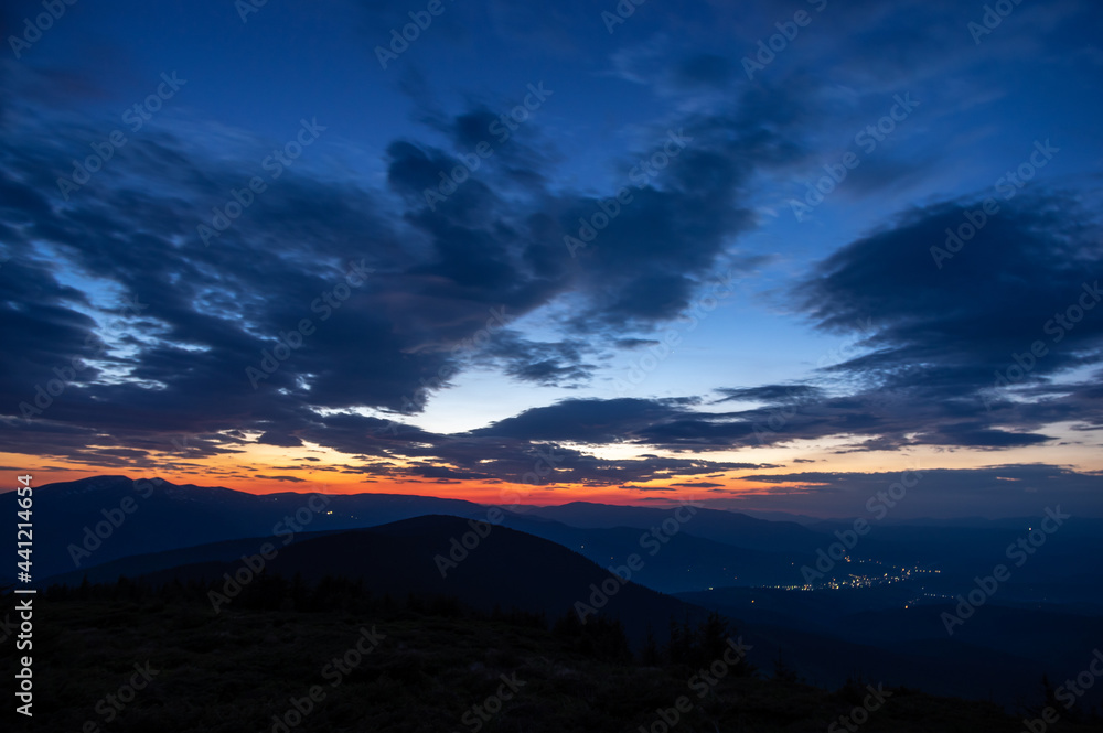 Beautiful multicolored sunset in the Carpathian mountains in summer. Evening landscape