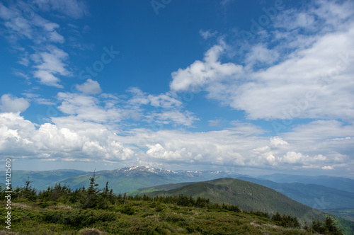 Mountain meadow, blue sky and clouds. View from the mountain