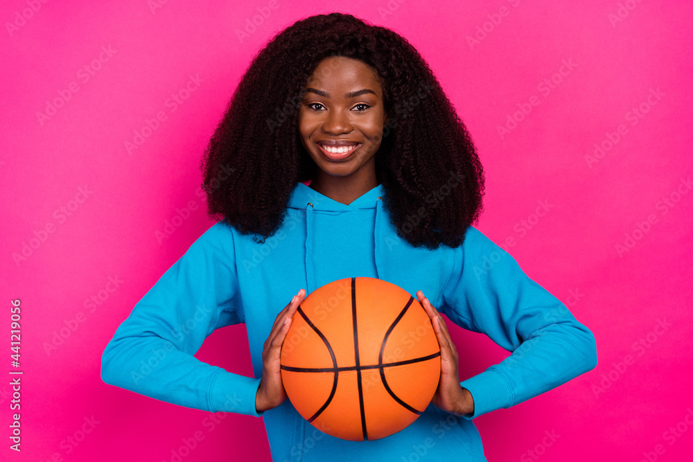 Photo portrait of woman smiling keeping ball spending free time isolated vivid pink color background