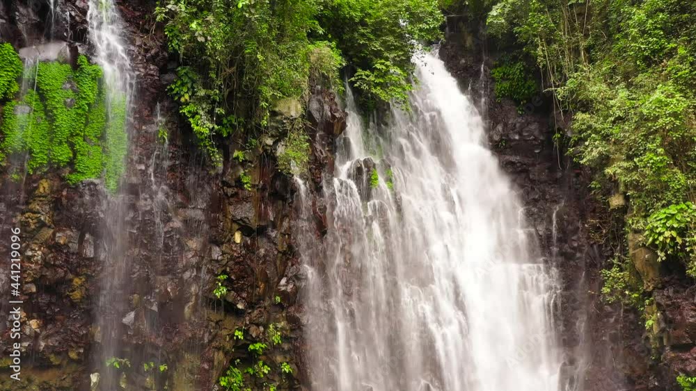 Waterfall in the rainforest view from above from above. Tropical Tinago Falls in mountain jungle. Philippines, Mindanao. Iligan City, Lanao del Norte. Waterfall in the rainforest view from above from above. Tropical Tinago Falls in mountain jungle. Philippines, Mindanao. Iligan City, Lanao del Norte.