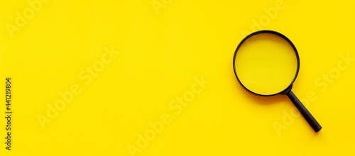 magnifying glass magnifier loupe search symbol on yellow background with copy space