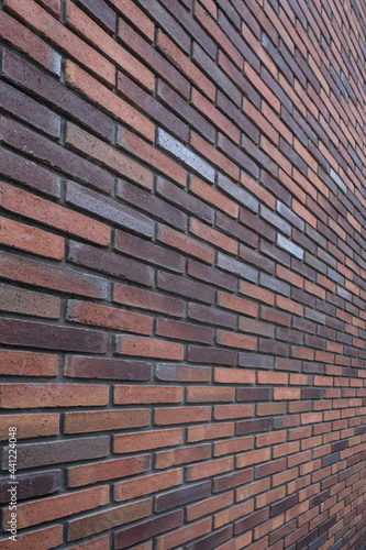 Brick wall in perspective, diverging or converging. Vertical image