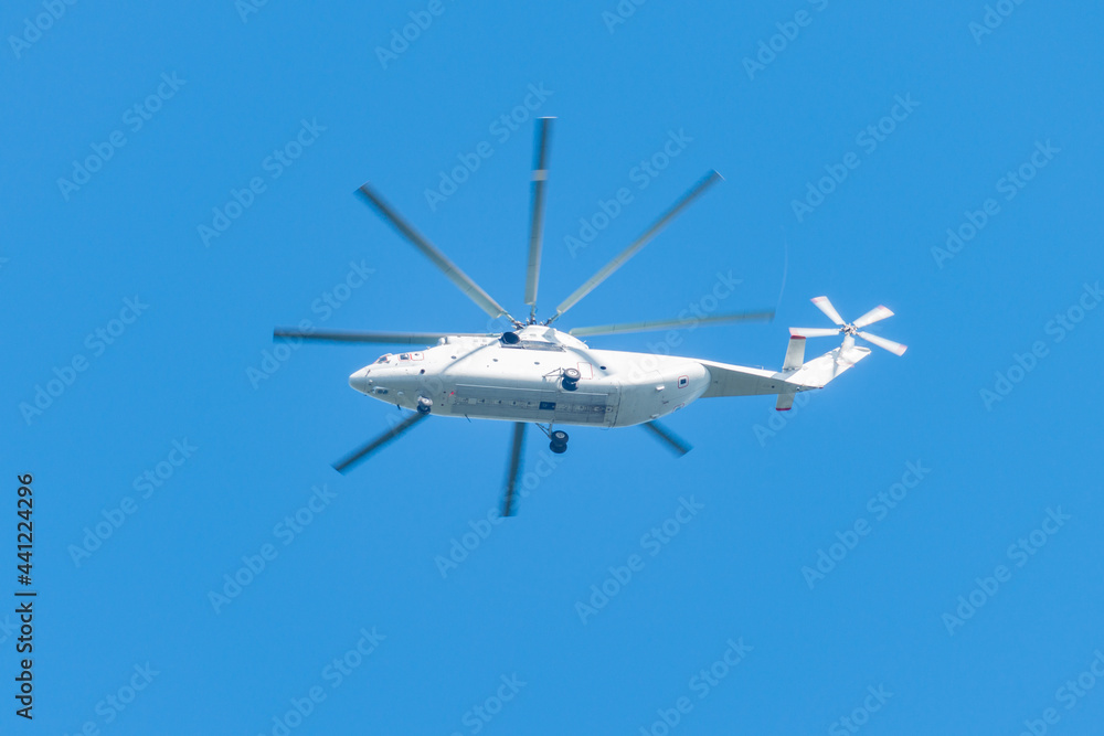 White transport helicopter flying in the sky. White transport helicopter flying in the sky.