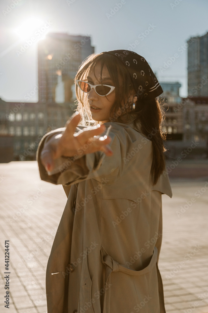 Fototapeta premium Beautiful young caucasian woman wearing trench coat