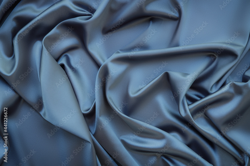 Obraz premium Elegant soft abstract gray background. Delicate silk waved fabric with copy space for design projects. Toned image.