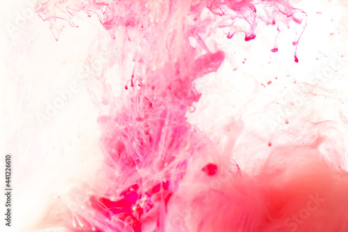 blurred pink ink acrylic color dropping in water abstract background