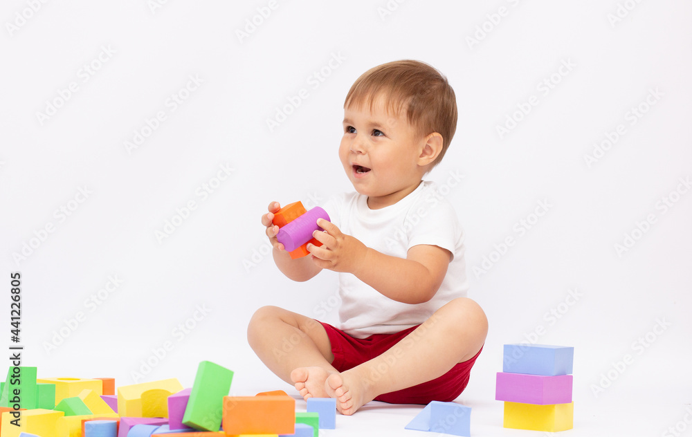 Little boy playing with building blocks, isolated Little boy playing with building blocks, isolated