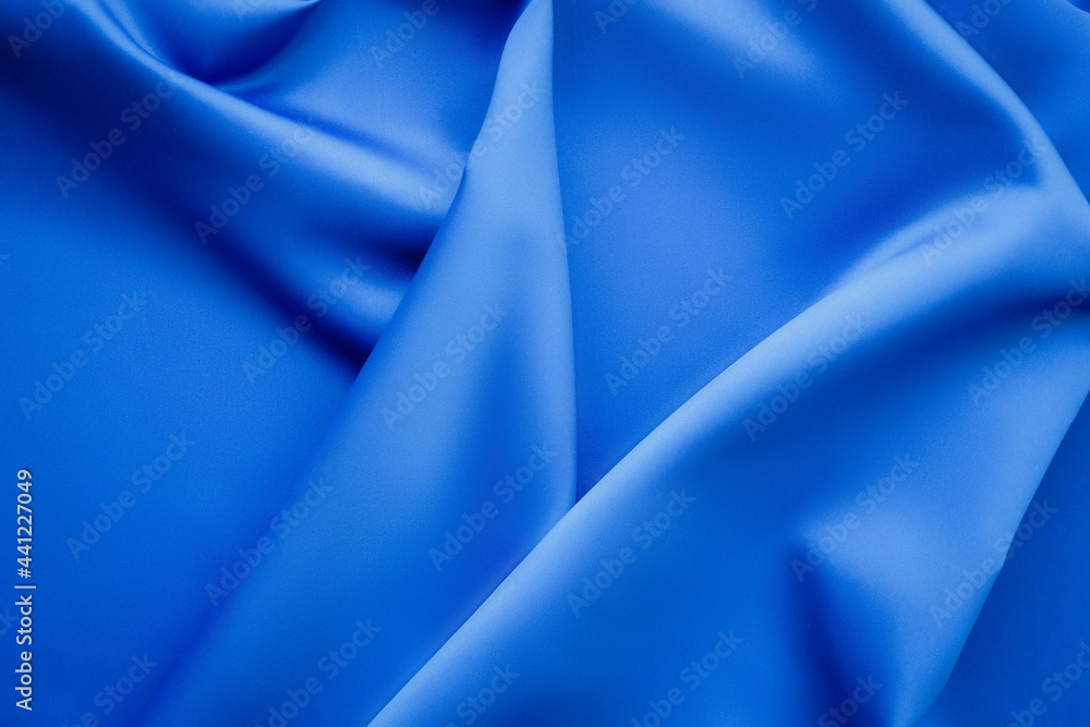 Elegant soft abstract blue background. Delicate silk waved fabric with copy space for design projects Elegant soft abstract blue background. Delicate silk waved fabric with copy space for design projects