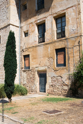 Ancient stone facade of a house and garden in front of it. Oña, Burgos, Merindades, Spain, Europe © Majopez