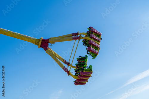 Pendulum ride flying under blue sky in amusement park