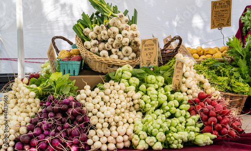 A display of vegetables at a farmers market in Salem, Oregon - radishes, new potatoes, garlick