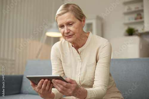 Senior woman using digital tablet at home. The use of technology by the elderly.