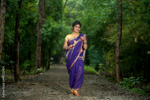 Fototapeta Naklejka Na Ścianę i Meble -  Indian Traditional Beautiful young girl in saree posing outdoors