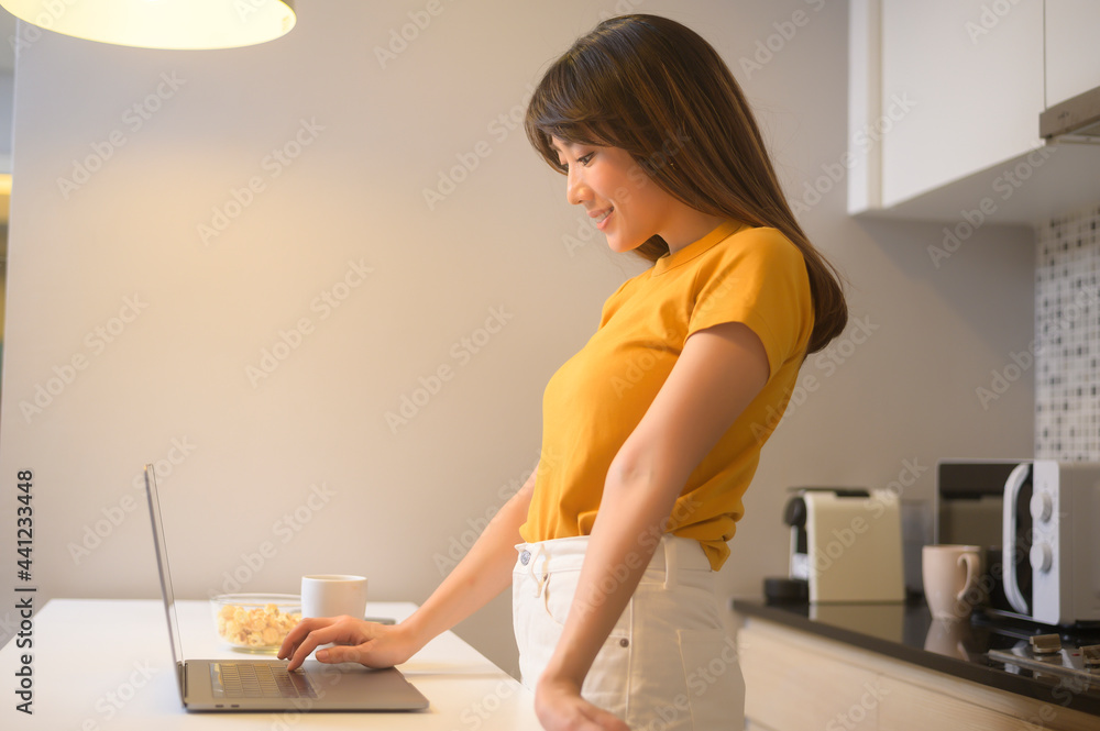 Young female working with her laptop and having a cup of coffee, life style and business concept Young female working with her laptop and having a cup of coffee, life style and business concept