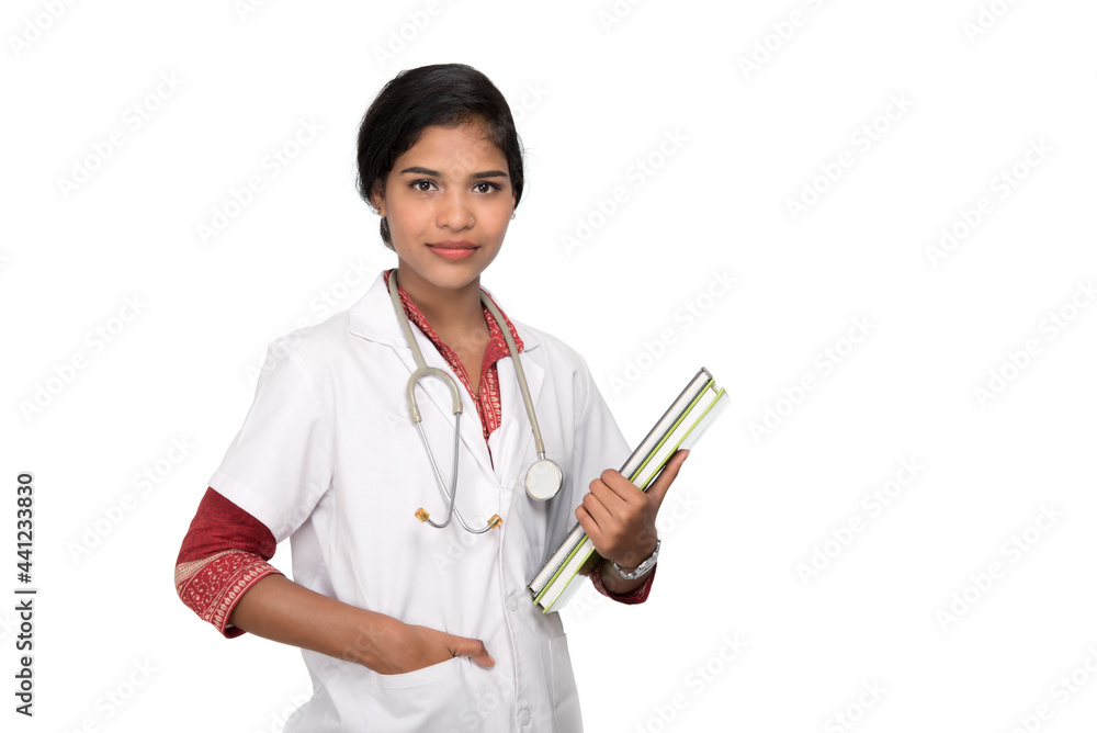 Young woman doctor holding book with stethoscope Young woman doctor holding book with stethoscope