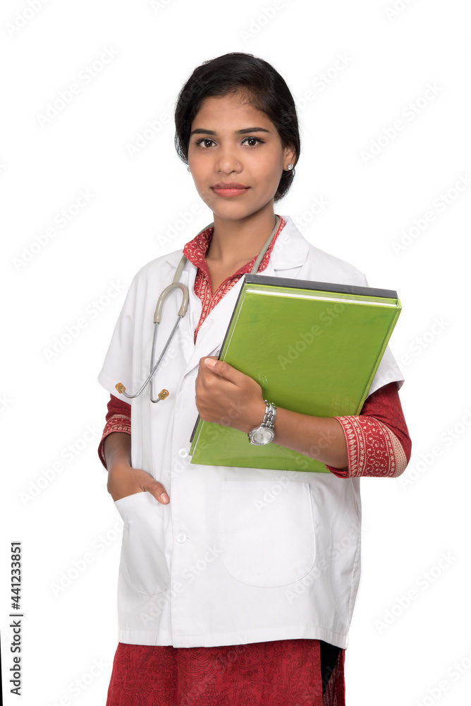Young woman doctor holding book with stethoscope Young woman doctor holding book with stethoscope