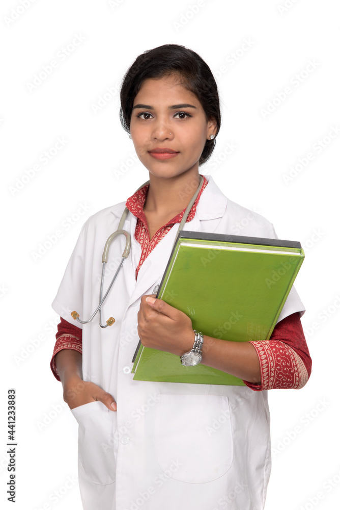 Young woman doctor holding book with stethoscope Young woman doctor holding book with stethoscope