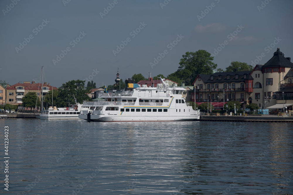 Commuting boat at the town Vaxholm in the archipelago of Stockholm Commuting boat at the town Vaxholm in the archipelago of Stockholm