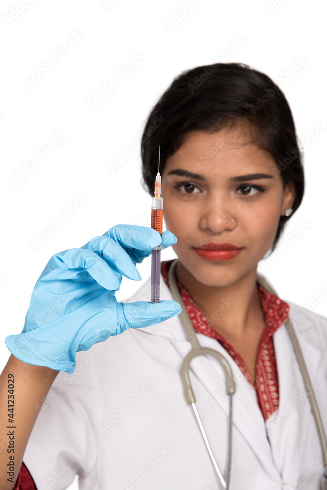 A female doctor with a stethoscope is holding an Injection or Syringe. A female doctor with a stethoscope is holding an Injection or Syringe.