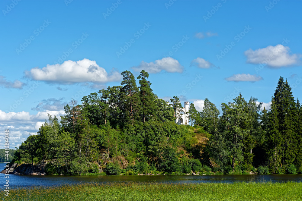 White turrets of the Chapel in Ludwigsburg Park mon repos in Vyborg on the background of blue sky.