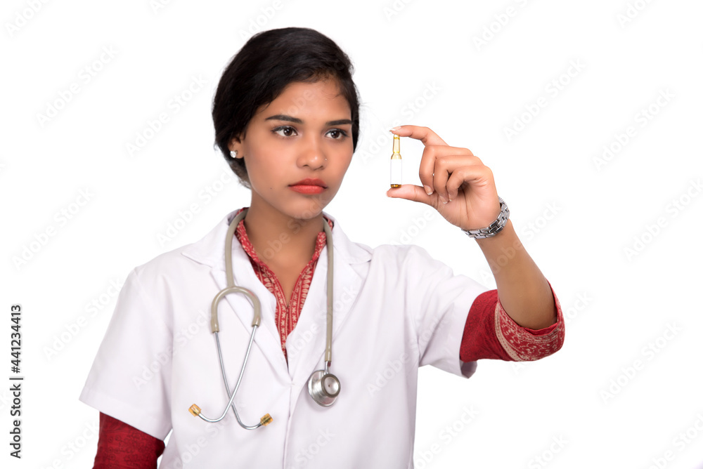 Female Doctor showing the tube of medicine on white background Female Doctor showing the tube of medicine on white background