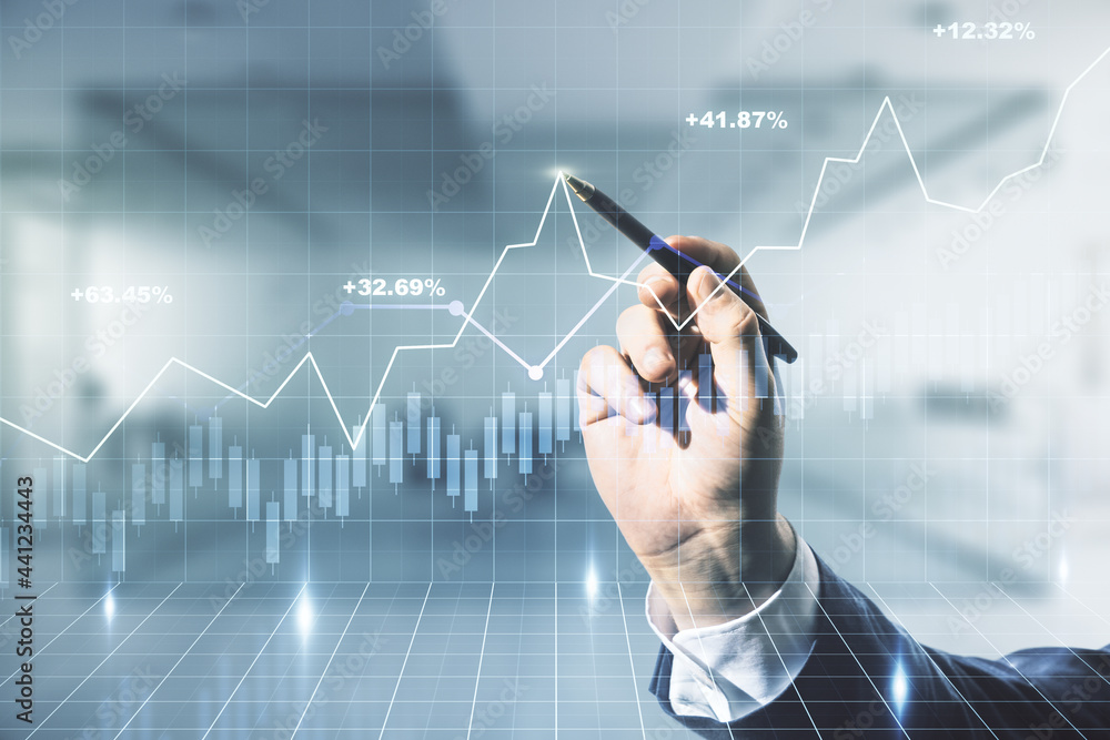 Multi exposure of trader hand with pen working with virtual abstract financial graph interface on blurred office background, financial and trading concept Multi exposure of trader hand with pen working with virtual abstract financial graph interface on blurred office background, financial and trading concept