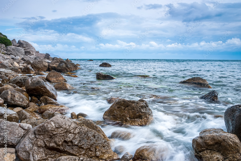 Seascape of the Crimean coast. Waves break into beautiful splashes against rocks. Seascape of the Crimean coast. Waves break into beautiful splashes against rocks.