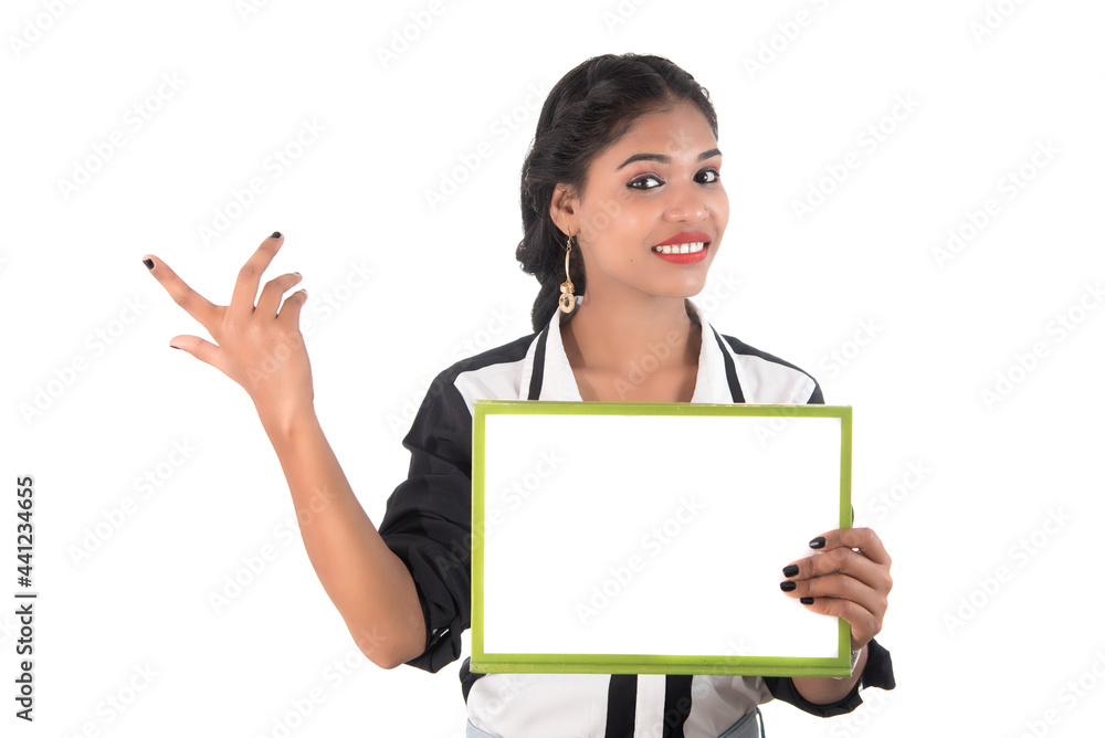 Girl holding blank white sign board on white background. Isolated portrait Girl holding blank white sign board on white background. Isolated portrait
