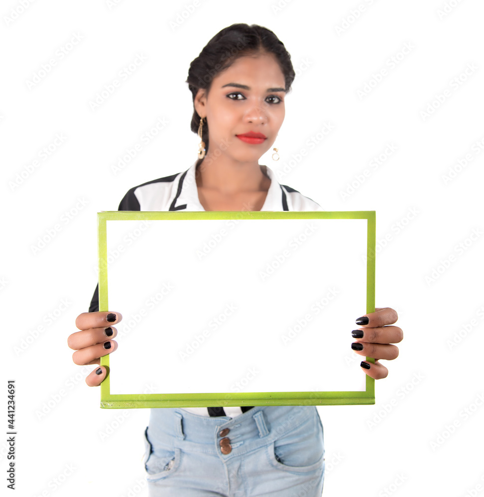 Girl holding blank white sign board on white background. Isolated portrait Girl holding blank white sign board on white background. Isolated portrait