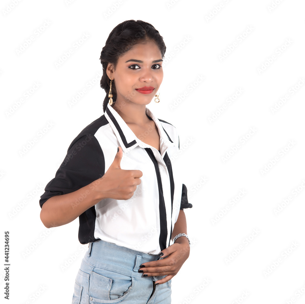 Smiling cheerful girl showing okay sign or thumbs up isolated on white background Smiling cheerful girl showing okay sign or thumbs up isolated on white background