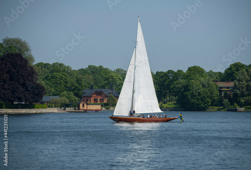 Old sailing ship with sails passing the island Djurgården in Stockholm