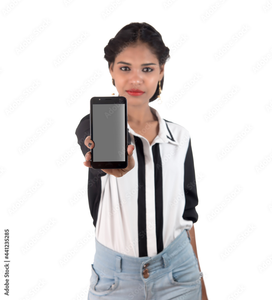 Young beautiful woman holding blank screen smart phone on white background Young beautiful woman holding blank screen smart phone on white background