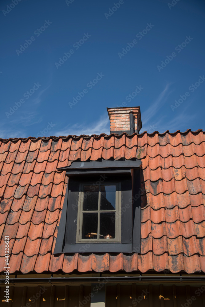 Roof with dormer and chimney on an old 1700s house in Stockholm