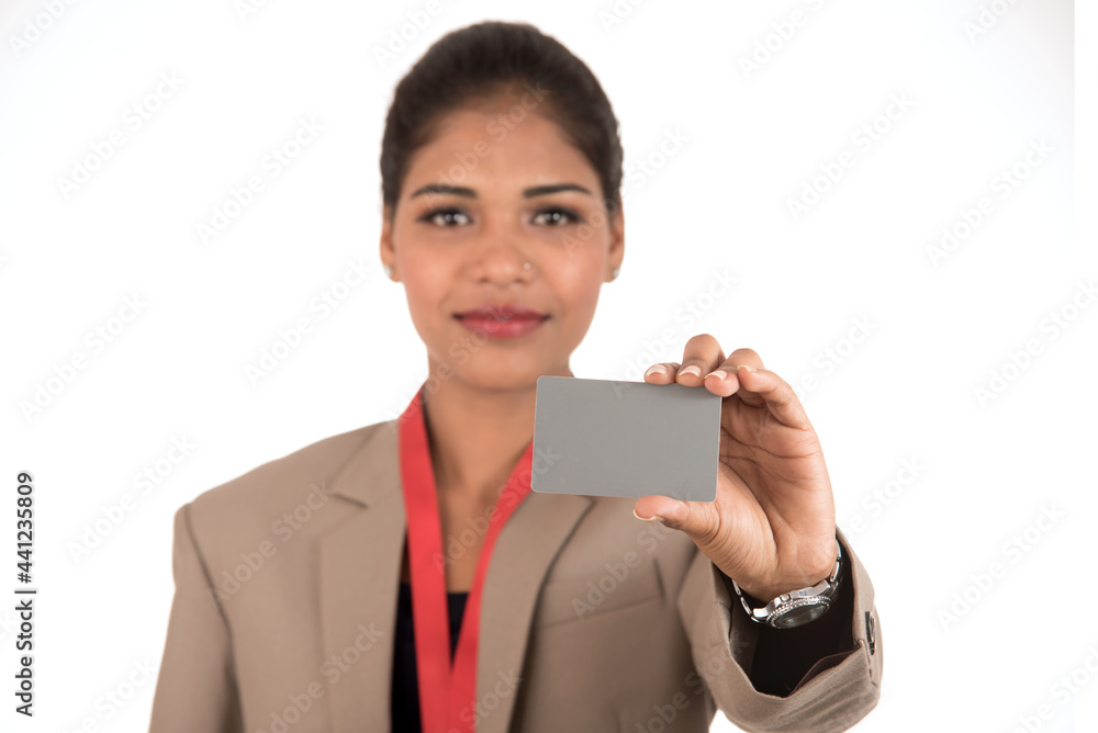 Smiling business woman holding a blank business card or ID card over white background Smiling business woman holding a blank business card or ID card over white background