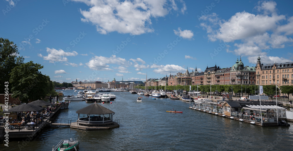 Bridge view over the bay Ladugårdsviken with boats and amusement buildings in Stockholm