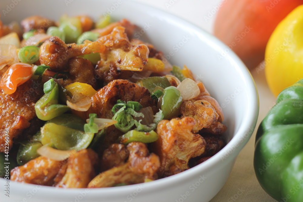 Cauliflower florets marinated fried and sauteed in sauces with onions and bell peppers. An Indo Chinese starter dish. Locally known as Gobi Manchurian.