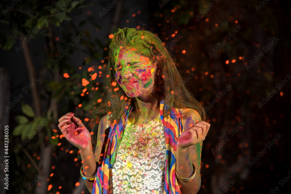 A young girl plays with colors. The concept for Indian festival Holi. color splash. A young girl plays with colors. The concept for Indian festival Holi. color splash.